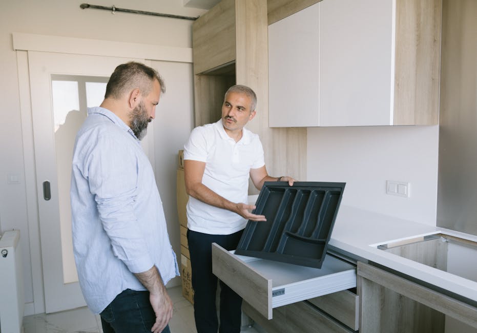 Contractor installing kitchen cabinets